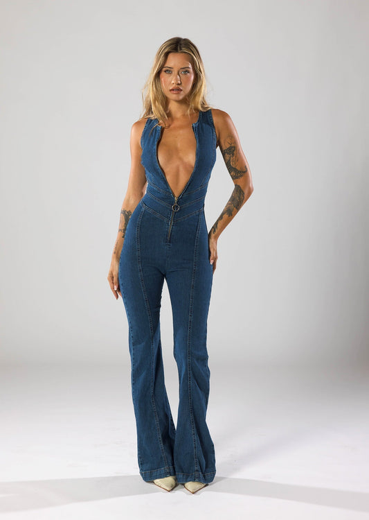 Model draagt Sienna denim jumpsuit – dames jumpsuit van stretch denim met diepe V‑hals, ritssluiting en flared pijpen | Becker’s Amsterdam